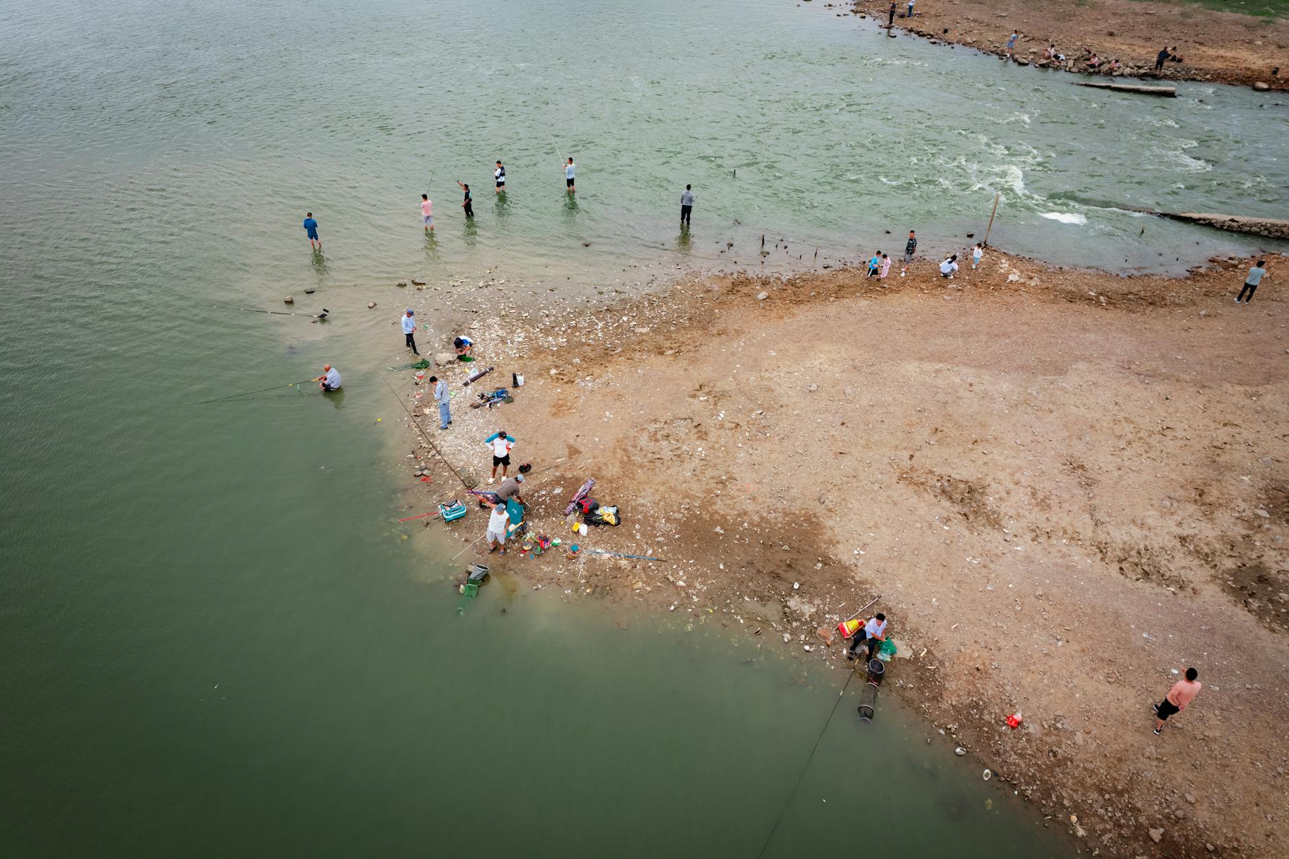 Wędkarze na zielonej Odrze na brzegu w Szczecinie